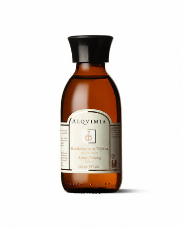 Aceite corporal reafirmante de ALQVIMIA: frasco ámbar con tapón negro, sobre fondo blanco.