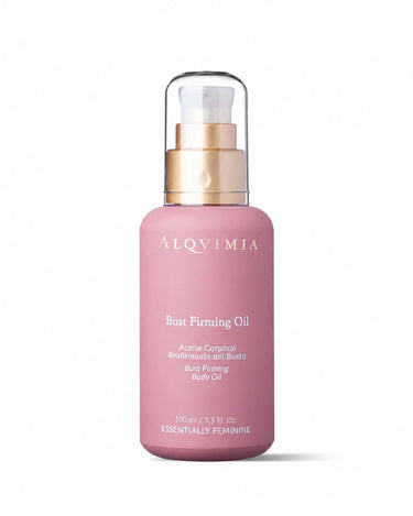 Aceite reafirmante de busto de ALQVIMIA: frasco rosa con dosificador dorado, sobre fondo blanco.