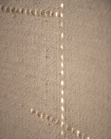 Sand wool rug with an openwork pattern by Linie Design, detail of texture and perforations