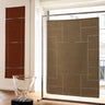 Sand wool rug with an openwork pattern by Linie Design, displayed as a wall textile beside a window