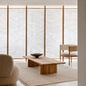 Sand wool rug with linen fringes by Linie Design, in a seating area with a low table