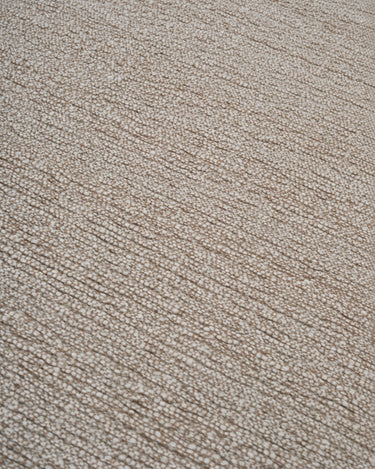 Beige wool rug with a fringed border by Linie Design, close-up of the central texture