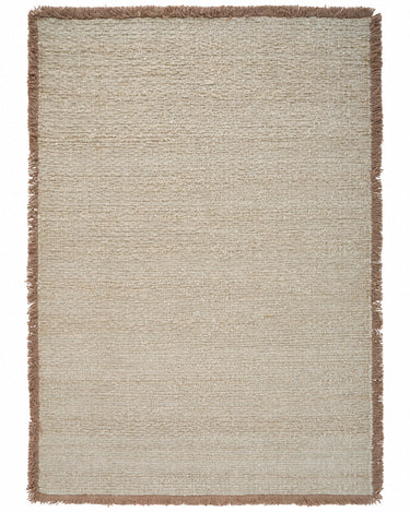 Beige wool rug with a fringed border by Linie Design, full view of the fringed border