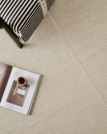 Kent rugs by Linie Design: detail of woven lines beside an armchair