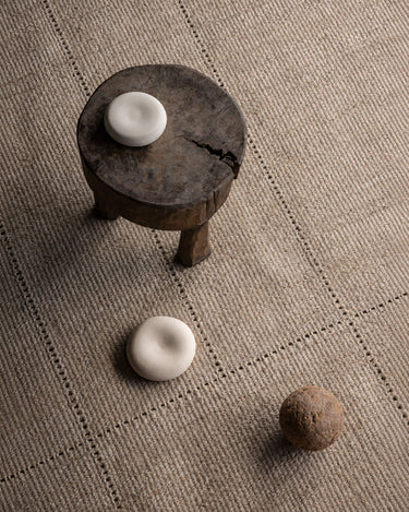 Still Aya rugs by Linie Design: detail of the weave beneath a round table
