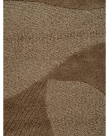 Alfombra irregular de lana ámbar con relieve de Linie Design: detalle de los cambios de altura del pelo.