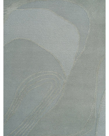 Alfombra de lana y seda verde menta con ondas de Linie Design: vista cercana de los segmentos curvos.