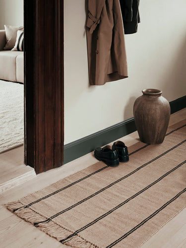 Alfombra pasillera Yuki junto a una cama