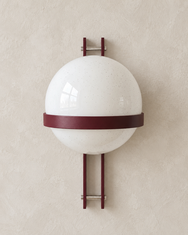 Burgundy Polinax wall light on a pale taupe limewash wall