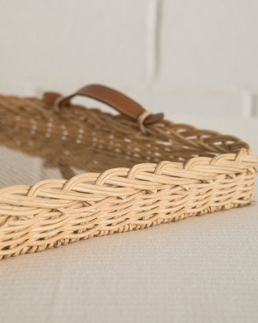 Detail of the leather handles on the rattan tray