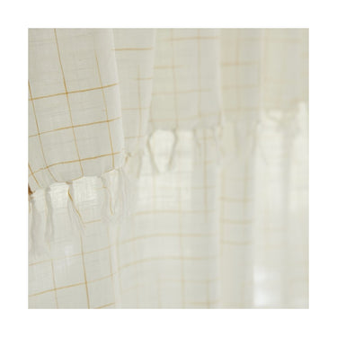 Detalle de tejido en cortina khadi cuadros ecru y curry