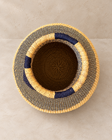 Vue de dessus du panier artisanal : ouverture circulaire, bord bicolore et intérieur tressé