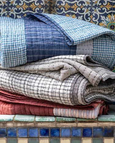 Caravane patchwork cotton quilt on a bed