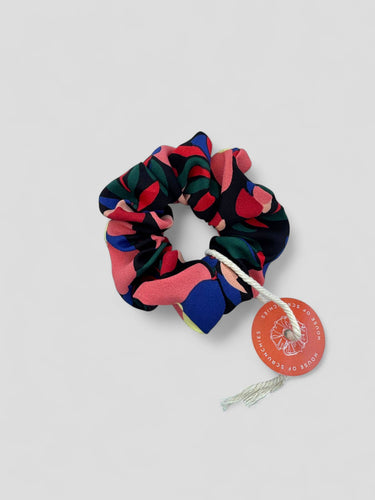 Coletero de House of Scrunchies: vista del coletero floral completo con etiqueta, modelo de flores coral y azul