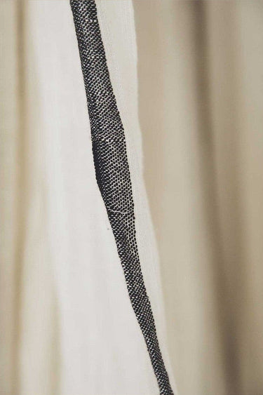 Surendra handcrafted linen-cotton curtain with a soft, light-filtering weave and fringed trim