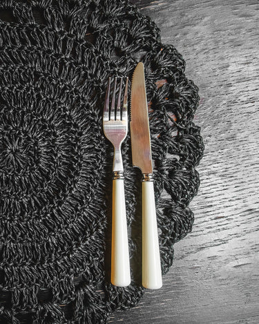 Ivory-coloured cutlery on a table