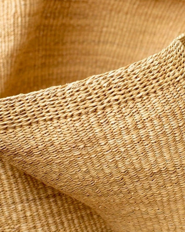 Detalle de cesta grande ondulada de fibras naturales