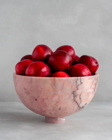 Frutero de mesa de mármol con pedestal de Kiwano Concept, rosa, con fruta roja