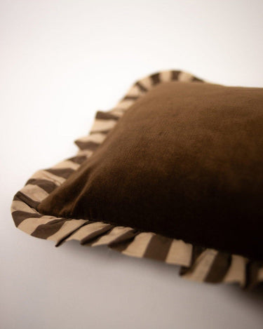 Brown striped ruffled cushion cover by Olsson & Jensen on a sofa