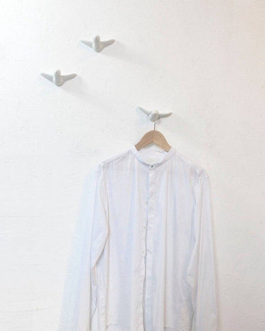 Ganchos de pared blancos con forma de pájaros