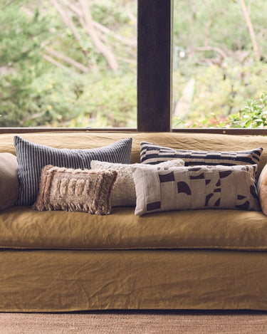 Linen and cotton patchwork cushion by HK Living in a textile arrangement