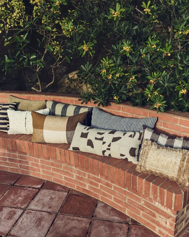 Linen and cotton patchwork cushion by HK Living in an interior setting
