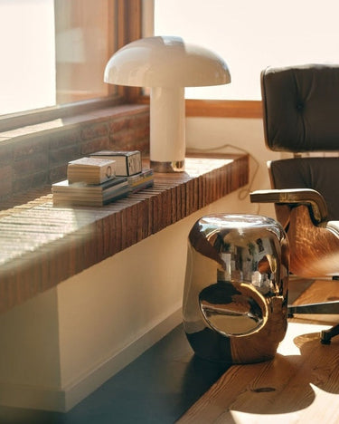 Chrome and ceramic side table by HK Living in a living room setting