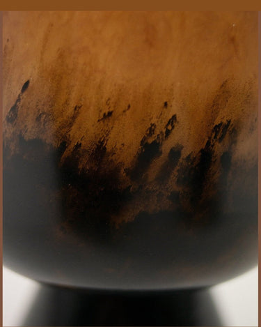 Detail of the veining on the low glass vase in earth tones