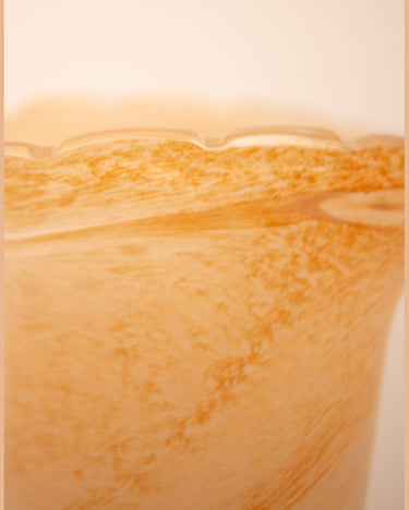 Detail of a peach ceramic vase in a living room or entrance hall