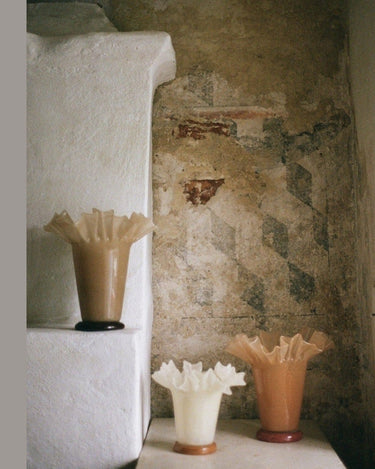Sculptural beige glass vase on a table