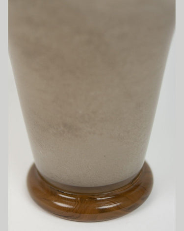 Detail of a compact taupe glass vase