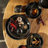 Small black ceramic plate by Bazar Bizar