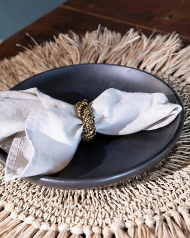 Small black ceramic plate by Bazar Bizar, detail view