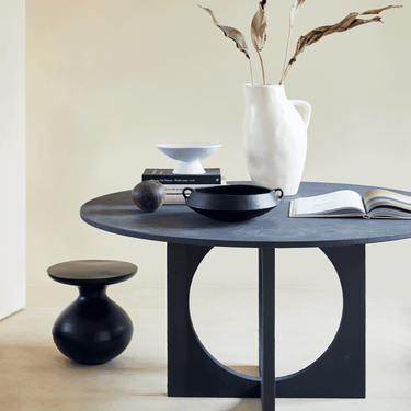 Mesa auxiliar de aluminio negro: vista del rincón de comedor con jarrón blanco