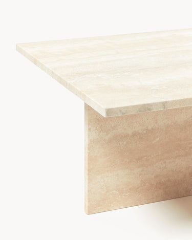 Detalle del borde recto del sobre y pata plana de piedra beige.