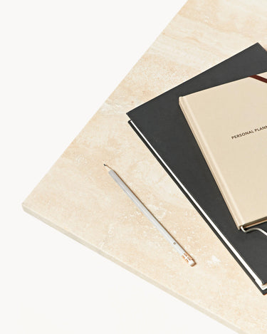 Detalle del sobre con cuadernos y lápiz.