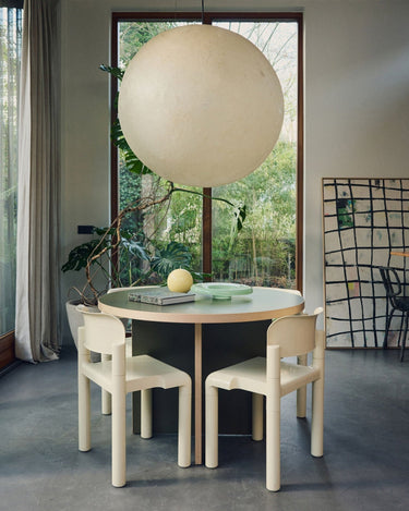 Small compact laminate round dining table by HK Living in a styled setting