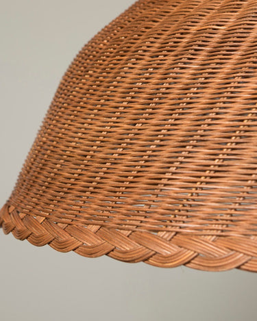 Brown rattan pendant shade in an interior setting