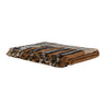 Plaid de lana y lino a rayas en tonos tierra de Bed and Philosophy, plegado con flecos visibles