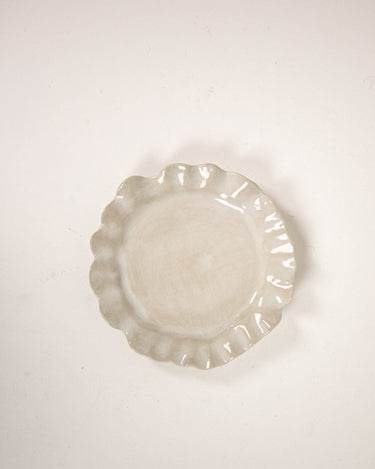 Close-up of a small white stoneware plate by Olsson & Jensen