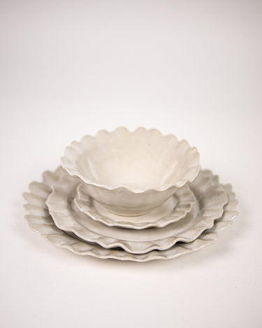 Small white stoneware plate on a laid table