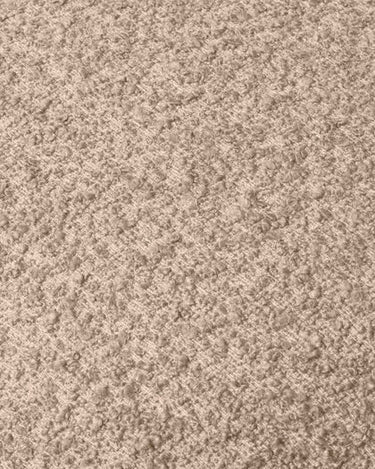 Primer plano del tejido bouclé beige claro.