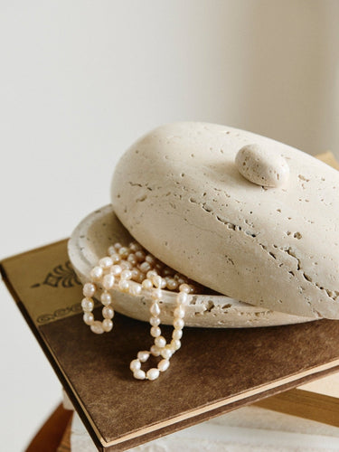 Natural pore detail of SITRA oval ivory travertine jar with lid – Nordal