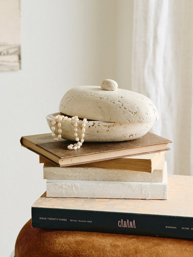 SITRA oval ivory travertine jar with lid in an interior setting – Nordal