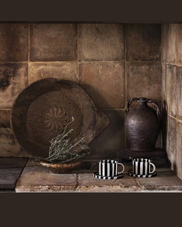 Striped ceramic cup by Olsson & Jensen on a styled table