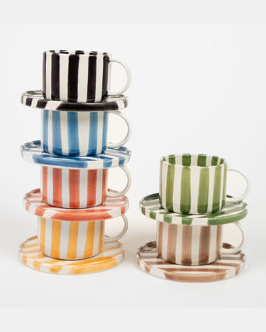 Detail of a green striped ceramic cup and saucer
