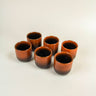 Vista principal completa de set de seis tazas de cerámica esmaltada roja