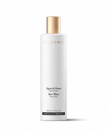 Tónico facial de rosas de ALQVIMIA: frasco blanco con tapón dorado, sobre fondo blanco.