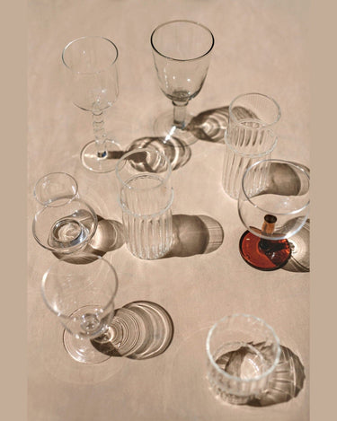 Tall glass tumbler by Olsson & Jensen in a dining setting