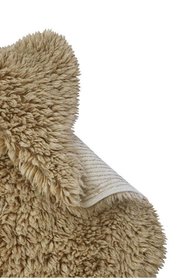 Alfombra Woolly beige sobre un asiento